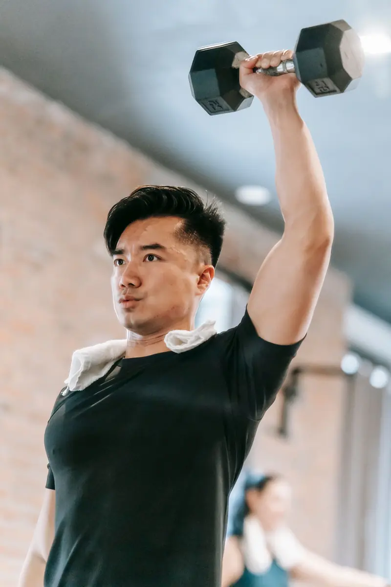 Homem treinando com halter na academia